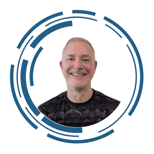 A headshot of Scott Idiens, he is wearing glasses and smiling